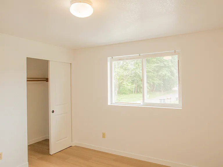 Bright room with freshly repainted walls, updated flooring, and a large closet for convenient storage. Clean, comfortable space with natural light.
