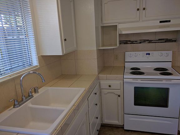 Sink and Stove and tiled countertops