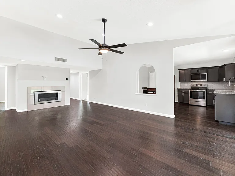Oversized living room with ethanol fireplace and convenient access to the kitchen.