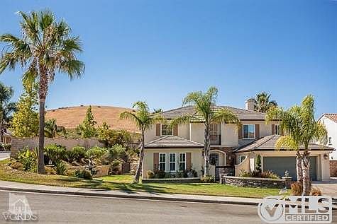 Palm trees in front and back give this home a tropical ambiance.
