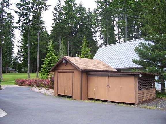 Even a storage shed, a golf cart garage and paved access to the green