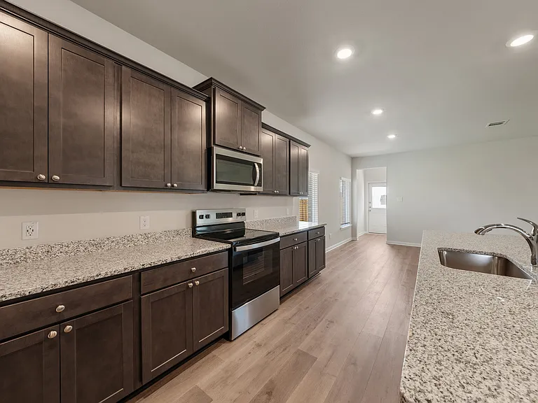 The kitchen has beautiful wood cabinetry.