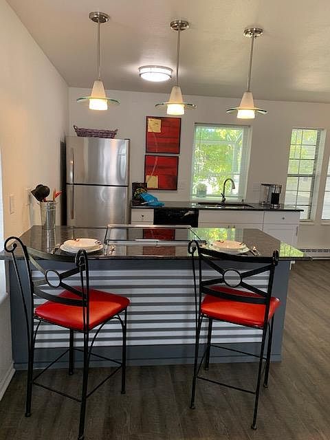 Dramatic black granite counters and breakfast bar