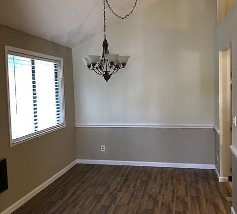 High ceiling in dining room, wide blinds, chair molding and new hard wood floors.