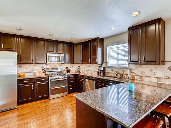 Kitchen with double oven, new appliances, and granite counte