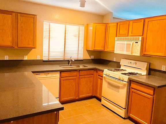 Kitchen view of microwave and range oven