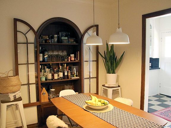 Dining Room with Vintage China Cabinet in Charming 2 BDR/1 BA Retro Row Duplex Apartment.