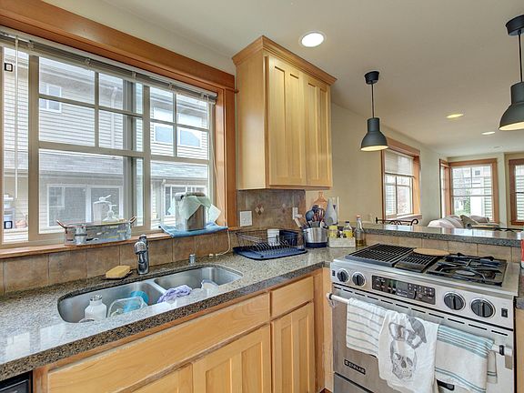 Kitchen with Maple cabinets, quartz counters, down draft stove, overlooking the Dining & Living rooms