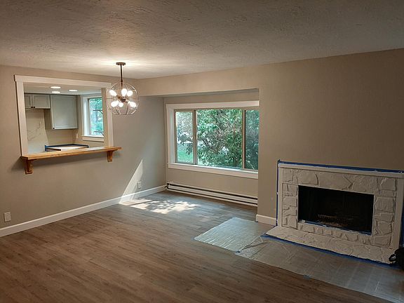 The view of the living room and the kitchen breakfast bar with butcher block counter.