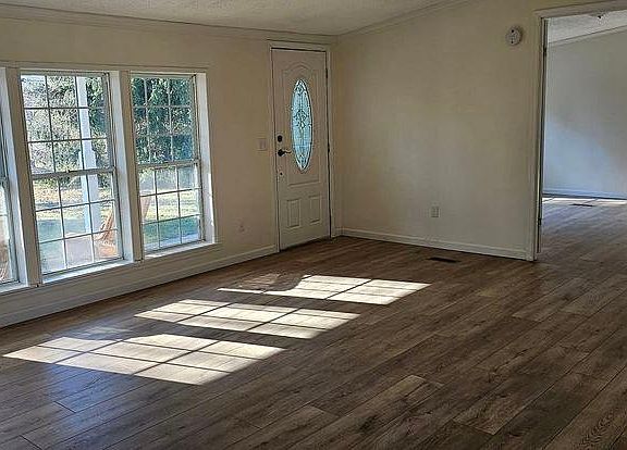 Set up your living room or dining room in this flexible space filled with light and built in storage.