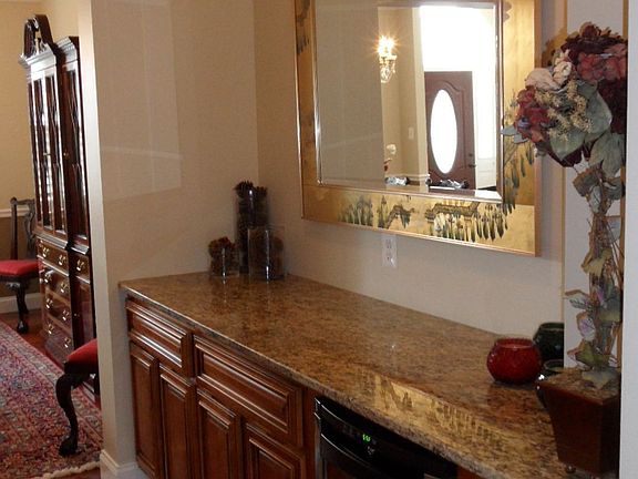 Butlers Pantry with cherry cabinets, granite and wine refridgerator