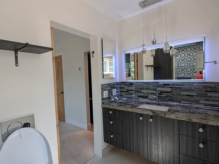 Primary bath, has a toto washlet toilet, lighted mirrors, and plenty of counter space.
