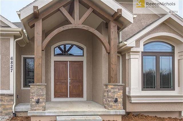 Gorgeous Arched Wood Beams  and Double Doors Welcome You Home