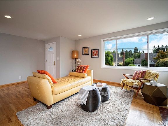 The living room is simply a gorgeous, restful space with hardwood floors, updated quality Pella brand wall of windows, and fresh paint virtually throughout the home.  