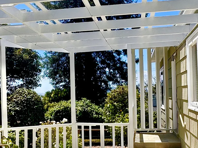 The atrium features a striking midcentury modern trellis.