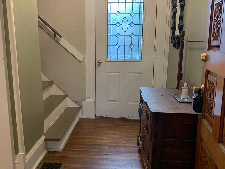 Large foyer with steps to second level and door to the 1st floor