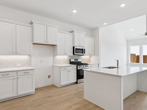 Kitchen in the Hanna Floorplan at Midtown GP in Grand Prairie, TX.
