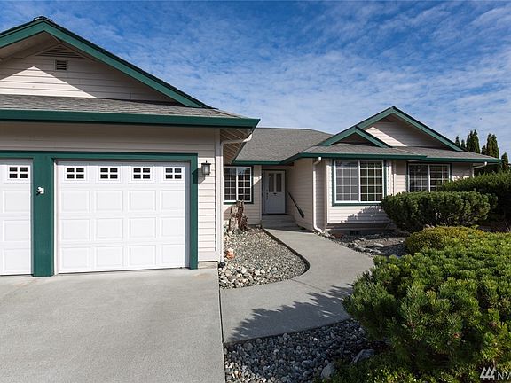 On left is fenced patio, then RV parking on left side of 20' long shop and double garage.  Long concrete driveway and turn around space with property set back about 70' from the road. Lot is about 325 x 105.  