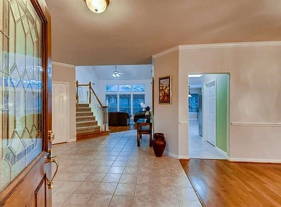 Inviting tile entryway with open walkway to dining, kitchen or family room.