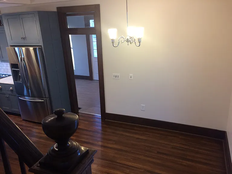 standing on stairs looking across the dinning room into the back playroom or porch or pantry area