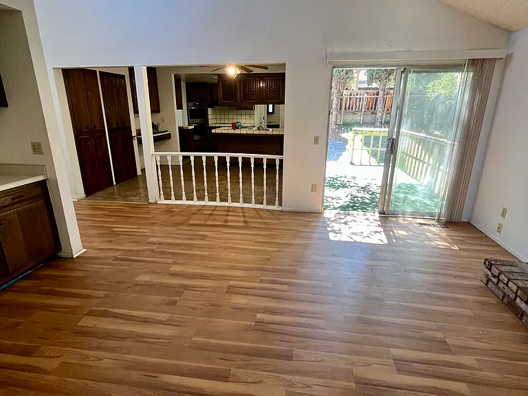 The family/entertaining room features a brick wood fireplace and a wet bar.