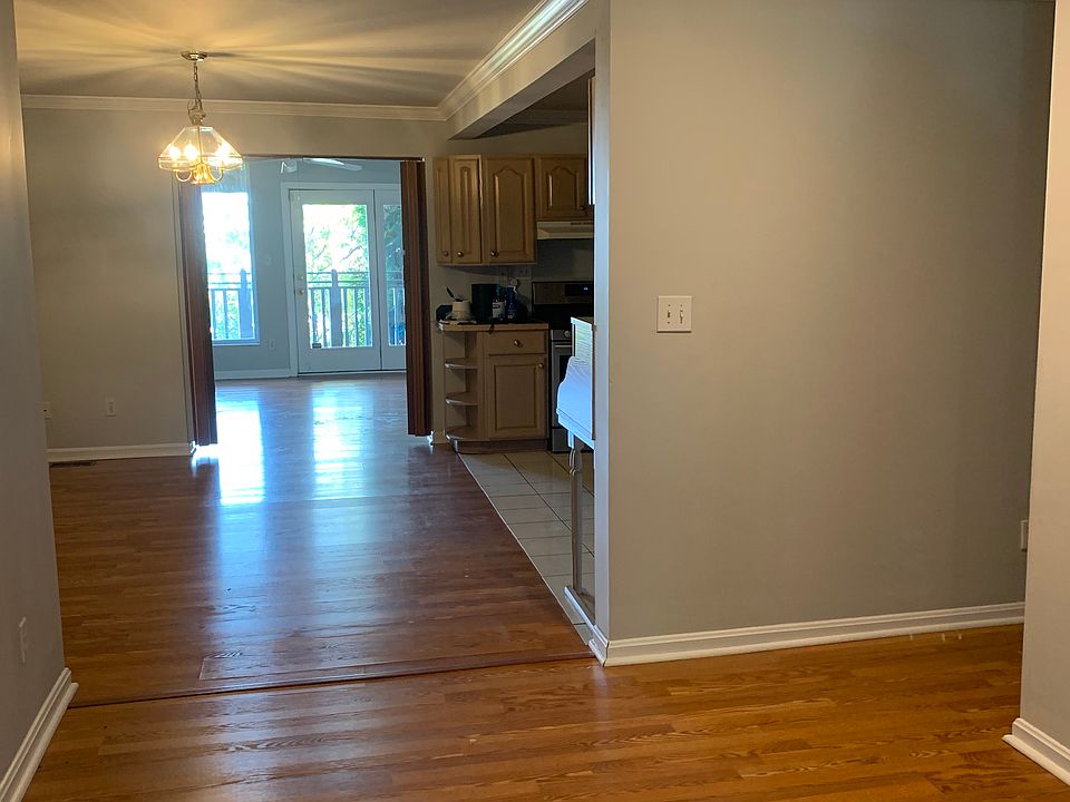 Entryway, sitting area, kitchen and further down, living room leading to deck