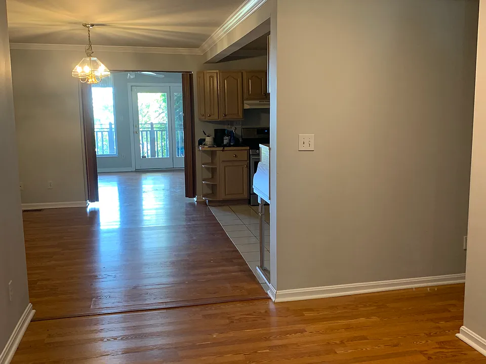 Entryway, sitting area, kitchen and further down, living room leading to deck