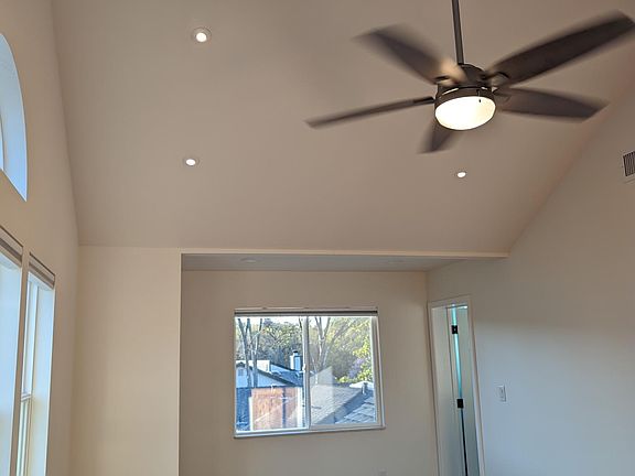 ceiling fan and light in the vaulted ceiling of the M-Bedroom