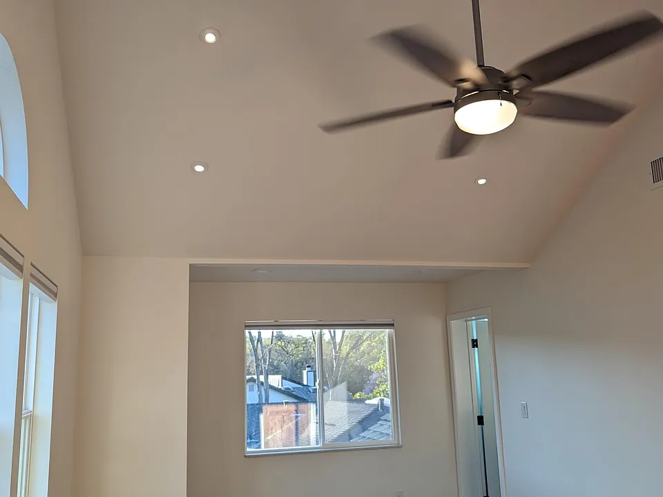 ceiling fan and light in the vaulted ceiling of the M-Bedroom