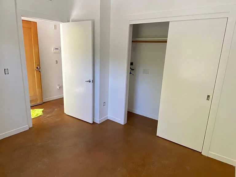 Bedroom 1, accessed from the hallway, right next to the front door.
