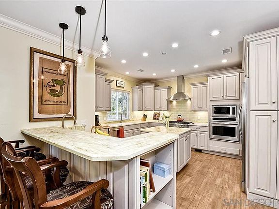 Large kitchen with commercial grade appliances, separate food prep sink, island and gas range - fully stocked for you!
