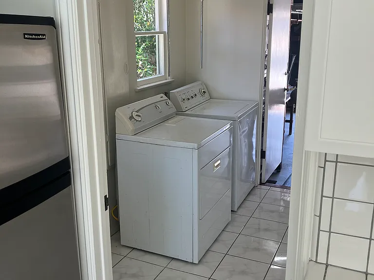 washer / dryer room connected to kitchen and garage on the other side.