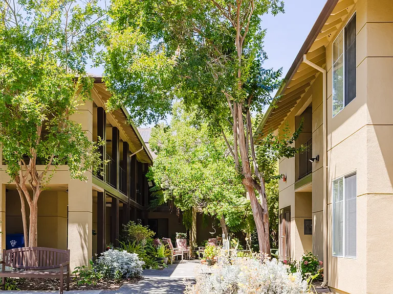 Tranquil courtyard setting with lush landscaping and welcoming walkways.