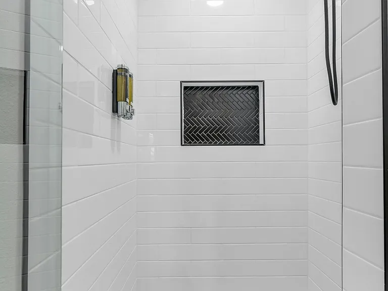 Shower with removable shower head wand. Shampoo and body soap provided.