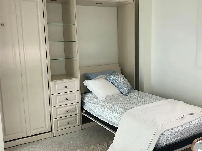 One of the murphy beds pulled down. 2 single beds