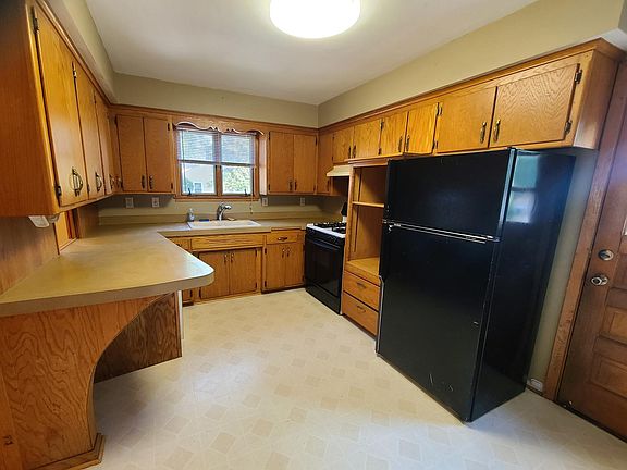 Kitchen has an abundance of cabinets and a dishwasher