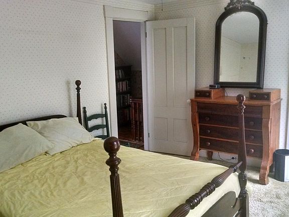 Front upstairs bedroom, antique bureau, double bed, and two large closets.