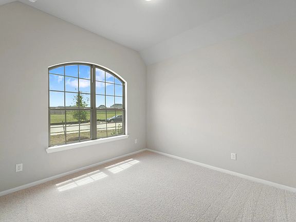 The secondary bedroom features plush carpet, fresh paint, closet, and a large window that lets in pl