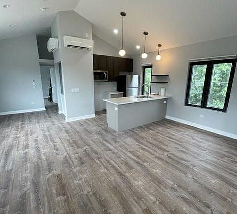 Open kitchen and living area (photo taken before new stove installation--see other photos)