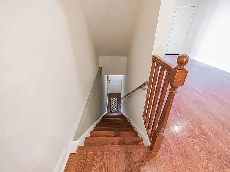 Second floor stairwell descending to first floor exit.