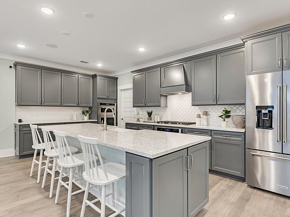 Large Kitchen with stunning grey cabinets ideal for storing pots, pans, and other items.