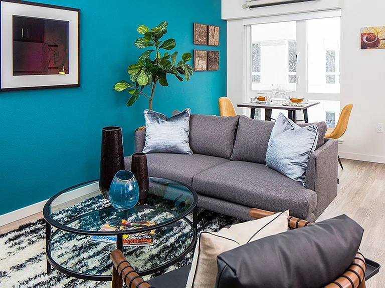 Living space with bold accent wall and stylish furniture for a fresh look.