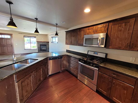 Front door, living room, and kitchen with gas stove.