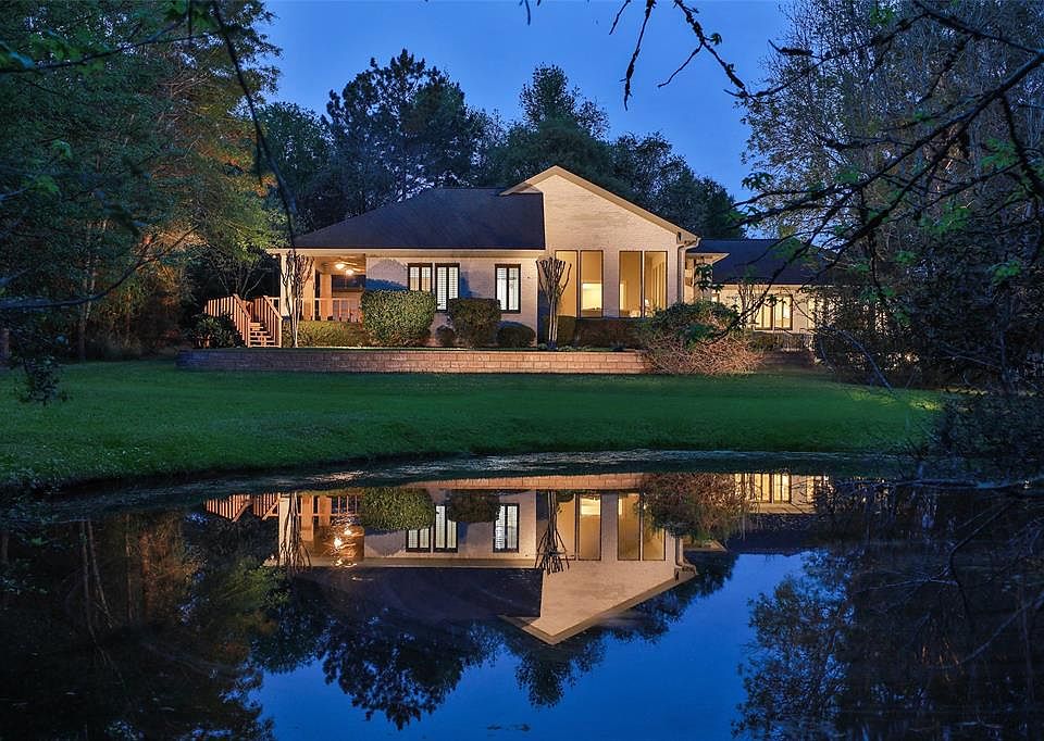 OVER THREE ACRES WITH IT'S OWN PRIVATE POND - This beautifully designed home is perfectly positioned on a 140,220 sf lot that exudes tranquility and charm. Custom built with 3 bedrooms 3.5 bath, & guest suite with full kitchen and living. Enjoy the s