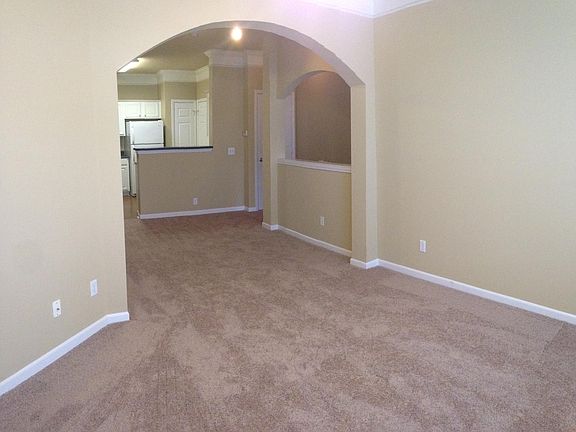 Arched wall dividing the living room, and dining room area. 