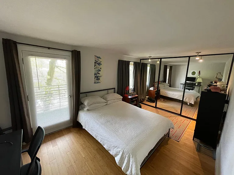 Master bedroom with large mirrored closet