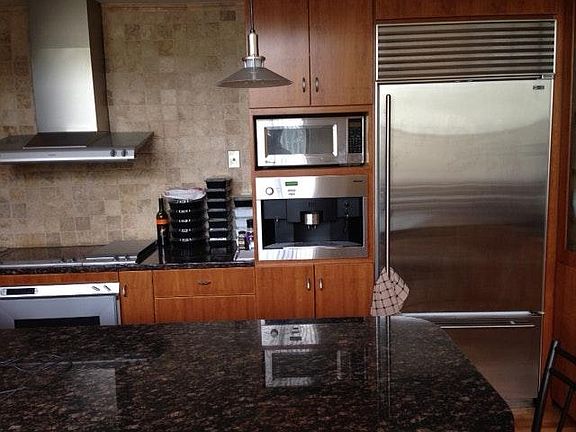 Kitchen with granite counters, built in coffee maker and other appliances