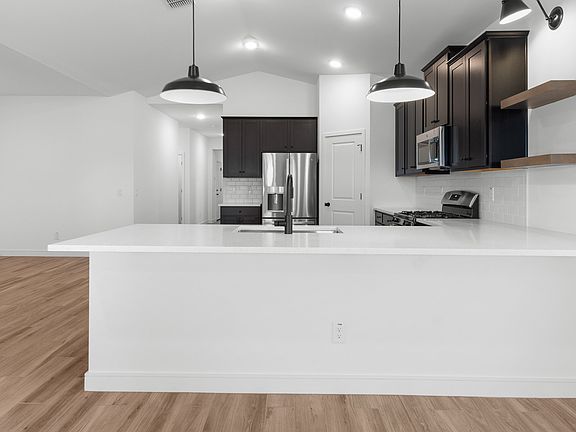 Kitchen with peninsula island pendant lights