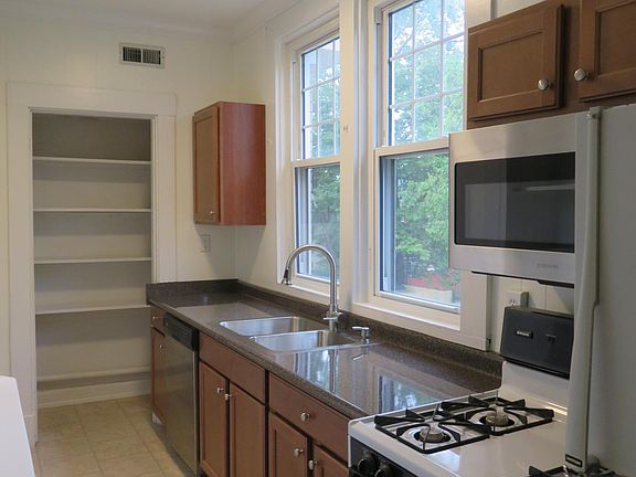 Galley Style Updated Kitchen w/ Pantry, Built-In Microwave, Gas stove, Dishwasher, Fridge.