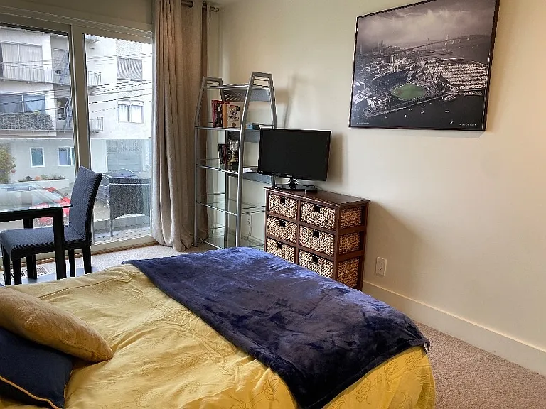 queen bedroom with balcony, desk/table, monitor and walk-in closet